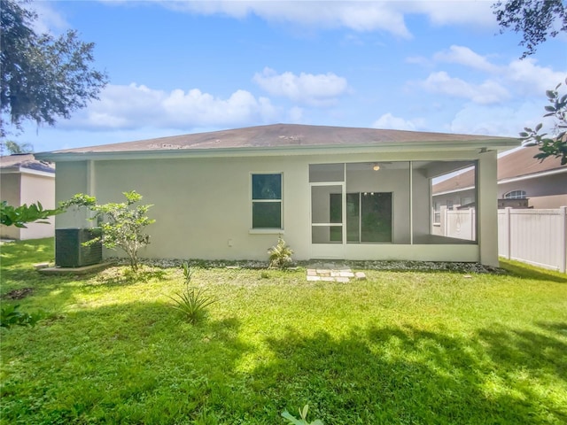 6303 Twin Bridges Dr, Zephyrhills, FL 33541 - back of house with stucco siding and a sunroom