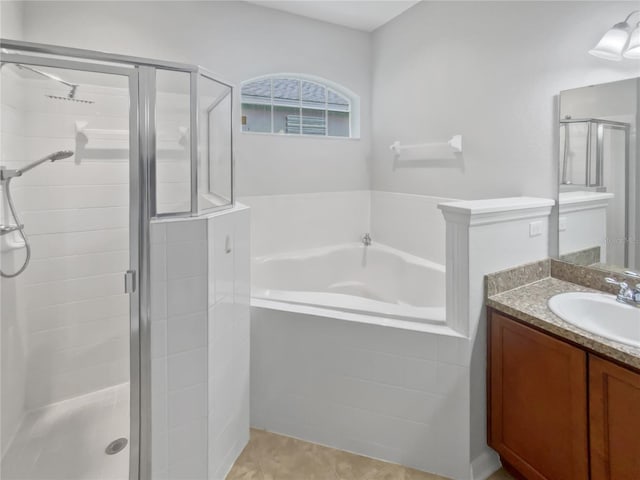 6303 Twin Bridges Dr, Zephyrhills, FL 33541 - bathroom with a shower stall, vanity, a garden tub, and tile patterned flooring