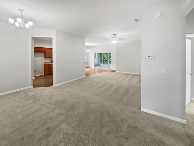 6303 Twin Bridges Dr, Zephyrhills, FL 33541 - unfurnished living room featuring carpet floors, a chandelier, and a ceiling fan