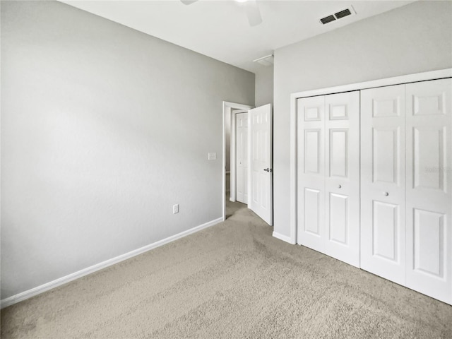 6303 Twin Bridges Dr, Zephyrhills, FL 33541 - unfurnished bedroom with carpet flooring, a closet, and a ceiling fan