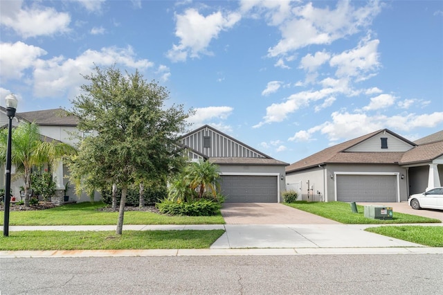 13205 Haystack Ct, Riverview, FL 33579 - view of front of house featuring a garage, concrete driveway, a front yard, and stucco siding