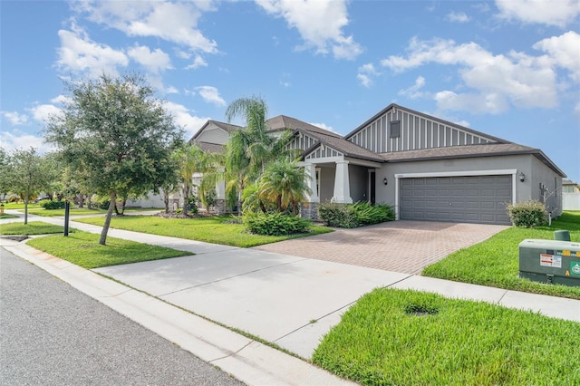 13205 Haystack Ct, Riverview, FL 33579 - view of front of property with decorative driveway, an attached garage, a front yard, and stucco siding
