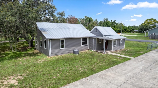 19402 E 5th St, Umatilla, FL 32784 - view of front of house featuring a porch and a metal roof