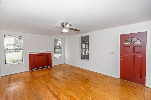 19402 E 5th St, Umatilla, FL 32784 - unfurnished living room featuring ceiling fan and light wood finished floors