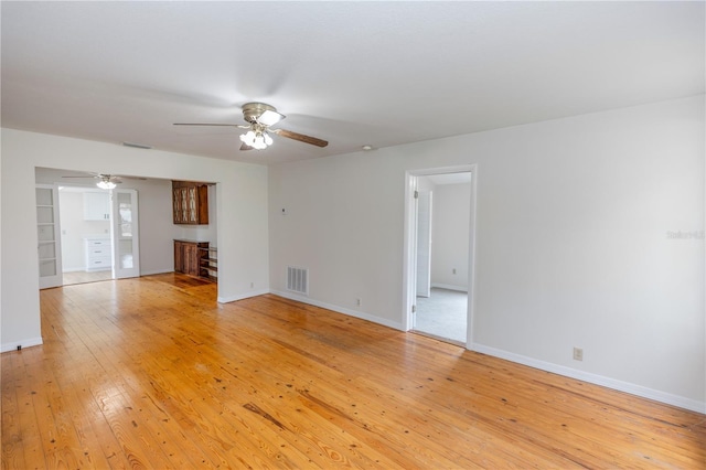 19402 E 5th St, Umatilla, FL 32784 - unfurnished living room with a ceiling fan and light wood finished floors