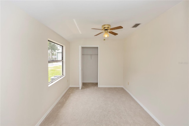 19402 E 5th St, Umatilla, FL 32784 - unfurnished bedroom with light carpet, a closet, and a ceiling fan