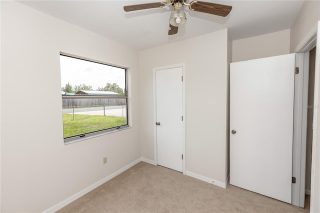 19402 E 5th St, Umatilla, FL 32784 - unfurnished bedroom featuring light carpet and ceiling fan