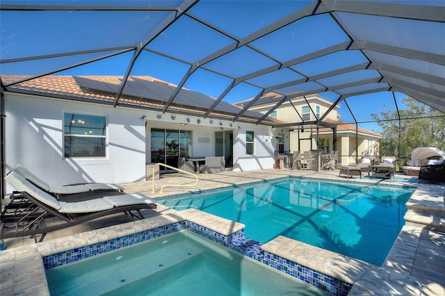8998 Croquet Ct, Champions Gate, FL 33896 - view of pool with a patio, a pool with connected hot tub, an outdoor hangout area, and a lanai