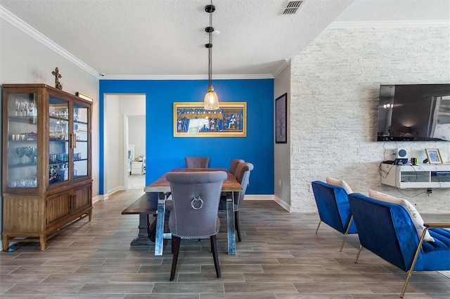 8998 Croquet Ct, Champions Gate, FL 33896 - dining area featuring a textured ceiling, wood finish floors, and crown molding