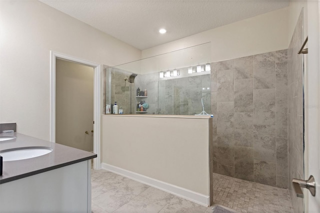 8998 Croquet Ct, Champions Gate, FL 33896 - bathroom featuring walk in shower, vanity, a textured ceiling, recessed lighting, and tile patterned floors