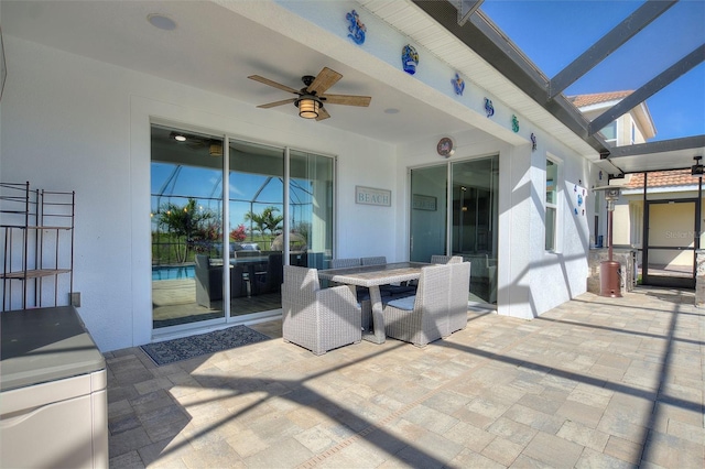 8998 Croquet Ct, Champions Gate, FL 33896 - view of patio / terrace featuring ceiling fan, outdoor dining area, and glass enclosure