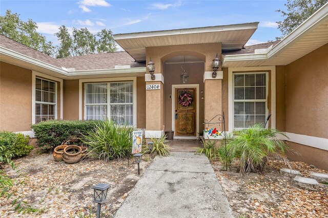 12404 SW 31st Ave, Archer, FL 32618 - entrance to property featuring stucco siding and roof with shingles