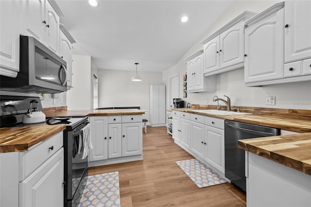 12404 SW 31st Ave, Archer, FL 32618 - kitchen featuring butcher block counters, stainless steel appliances, white cabinets, recessed lighting, and lofted ceiling