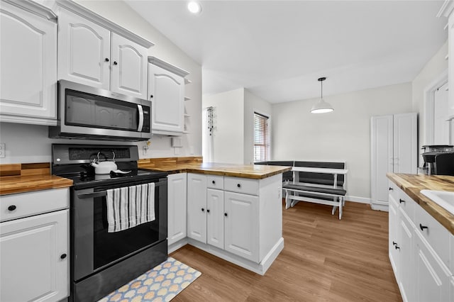 12404 SW 31st Ave, Archer, FL 32618 - kitchen with butcher block countertops, stainless steel microwave, black electric range oven, and recessed lighting