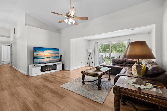 12404 SW 31st Ave, Archer, FL 32618 - living room featuring ceiling fan, wood finished floors, vaulted ceiling, and a glass covered fireplace