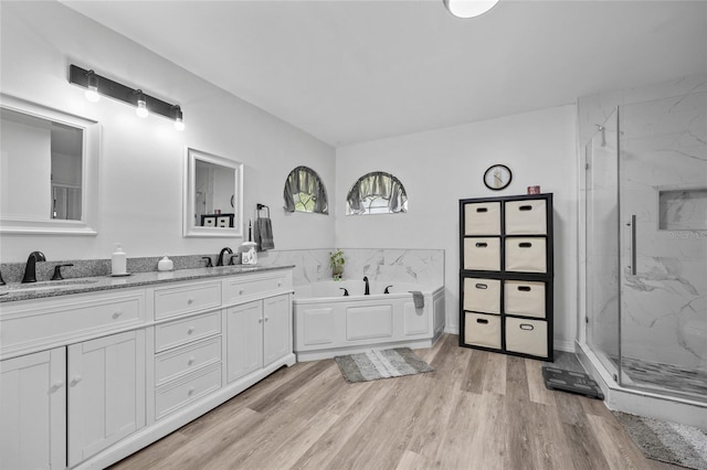 12404 SW 31st Ave, Archer, FL 32618 - bathroom with a marble finish shower, a bath, double vanity, and wood finished floors