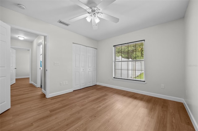 12404 SW 31st Ave, Archer, FL 32618 - unfurnished bedroom with light wood-style flooring, a closet, and a ceiling fan