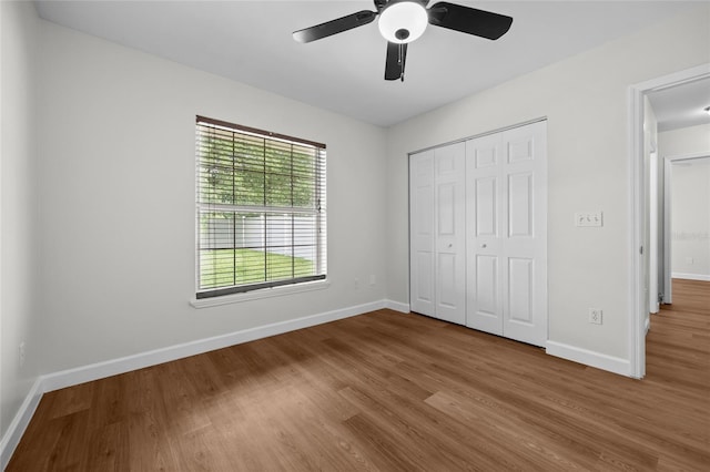 12404 SW 31st Ave, Archer, FL 32618 - unfurnished bedroom featuring wood finished floors, a closet, and ceiling fan