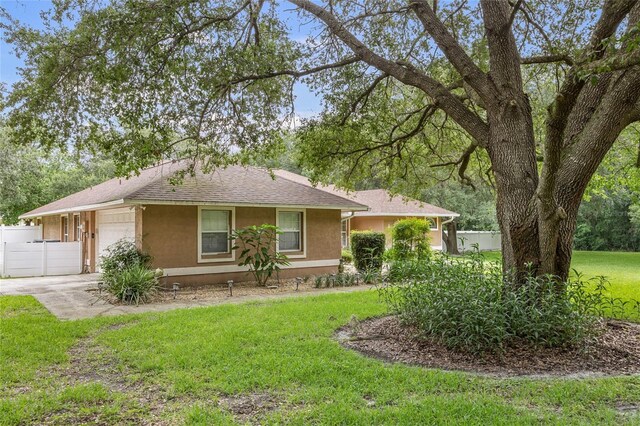12404 SW 31st Ave, Archer, FL 32618 - single story home featuring driveway, an attached garage, stucco siding, and roof with shingles