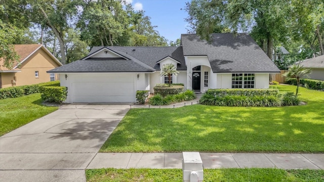 1237 Erik Ct, Altamonte Springs, FL 32714 - view of front of property featuring a shingled roof, an attached garage, stucco siding, a front lawn, and concrete driveway