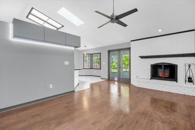 1237 Erik Ct, Altamonte Springs, FL 32714 - unfurnished living room with wood finished floors, a skylight, a ceiling fan, a brick fireplace, and high vaulted ceiling