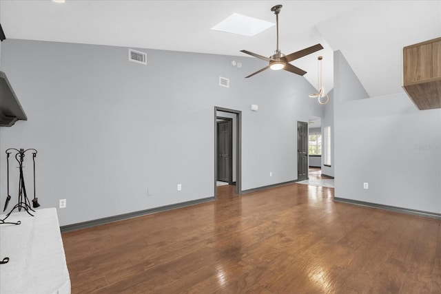 1237 Erik Ct, Altamonte Springs, FL 32714 - unfurnished living room featuring a ceiling fan, a skylight, wood finished floors, and high vaulted ceiling