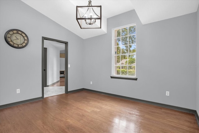 1237 Erik Ct, Altamonte Springs, FL 32714 - spare room with wood finished floors, a chandelier, and lofted ceiling