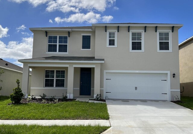 820 Silver Palm Dr, Haines City, FL 33844 - traditional-style home with stucco siding, driveway, an attached garage, covered porch, and a front lawn