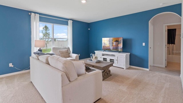 820 Silver Palm Dr, Haines City, FL 33844 - carpeted living area featuring arched walkways and baseboards