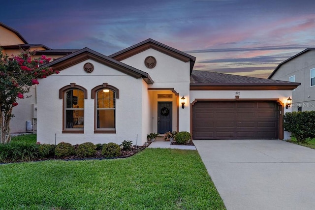 1193 Woods Landing Dr, Minneola, FL 34715 - view of front facade featuring an attached garage, a front yard, concrete driveway, and stucco siding
