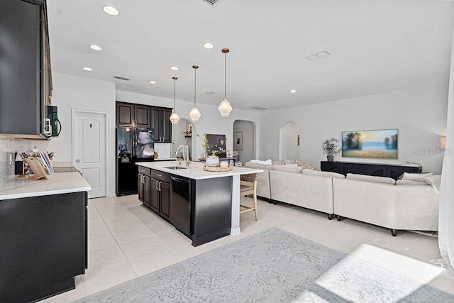 1193 Woods Landing Dr, Minneola, FL 34715 - kitchen featuring arched walkways, black appliances, light tile patterned flooring, open floor plan, and recessed lighting