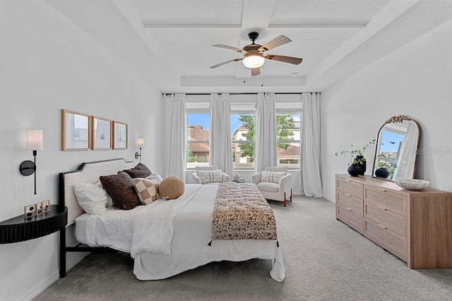 1193 Woods Landing Dr, Minneola, FL 34715 - bedroom featuring light carpet, a tray ceiling, and a ceiling fan