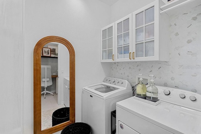 1193 Woods Landing Dr, Minneola, FL 34715 - laundry area featuring independent washer and dryer, cabinet space, and arched walkways
