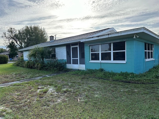 511 Pilaklakaha Ave, Auburndale, FL 33823 - view of front of house featuring a chimney, a front yard, and concrete block siding