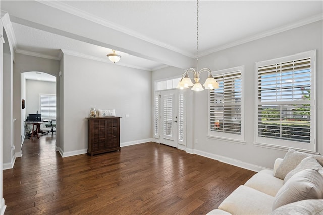 16415 Good Hearth Blvd, Clermont, FL 34711 - living room with a chandelier, healthy amount of natural light, dark wood-type flooring, arched walkways, and crown molding