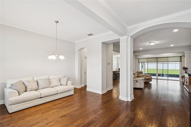 16415 Good Hearth Blvd, Clermont, FL 34711 - living area with arched walkways, dark wood finished floors, a chandelier, crown molding, and recessed lighting