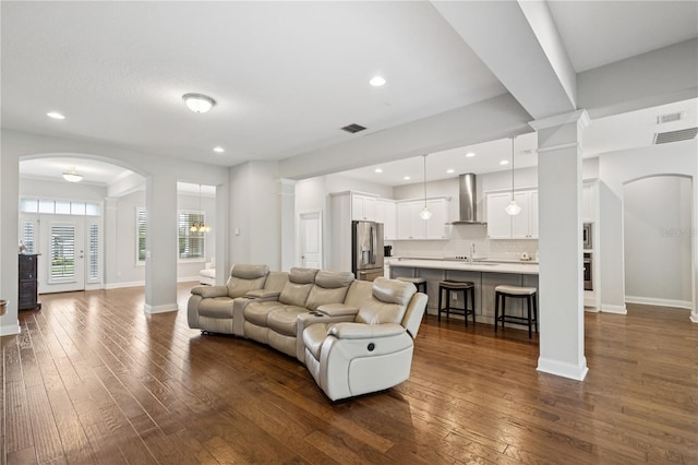 16415 Good Hearth Blvd, Clermont, FL 34711 - living area featuring decorative columns, dark wood-style flooring, arched walkways, and recessed lighting