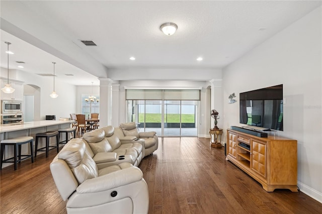 16415 Good Hearth Blvd, Clermont, FL 34711 - living area with ornate columns, dark wood-type flooring, plenty of natural light, and recessed lighting