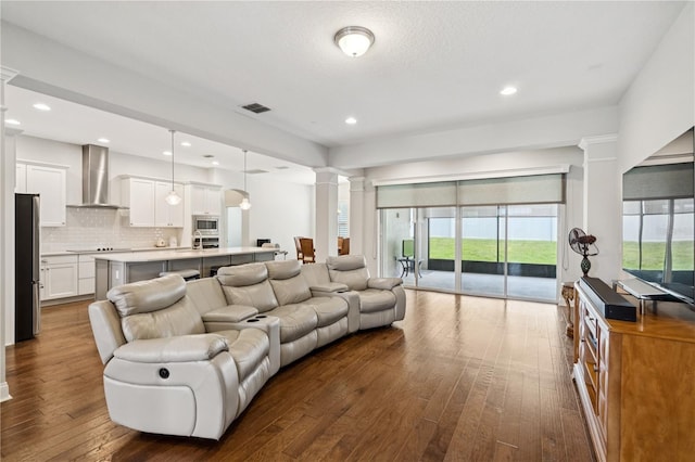16415 Good Hearth Blvd, Clermont, FL 34711 - living area featuring decorative columns, dark wood-style floors, and recessed lighting