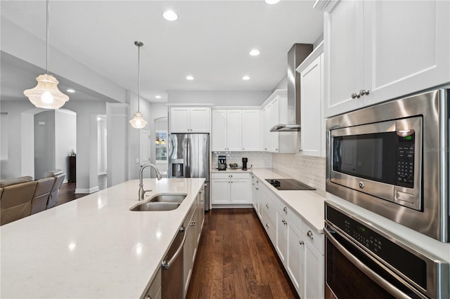 16415 Good Hearth Blvd, Clermont, FL 34711 - kitchen with appliances with stainless steel finishes, wall chimney exhaust hood, dark wood-style floors, white cabinetry, and recessed lighting