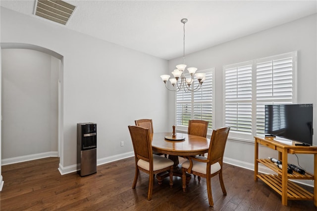 16415 Good Hearth Blvd, Clermont, FL 34711 - dining area with arched walkways, dark wood-type flooring, and a chandelier