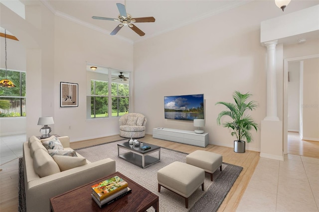 6029 Falconbridge Pl, Mount Dora, FL 32757 - living area featuring a ceiling fan, healthy amount of natural light, ornamental molding, wood finished floors, and a high ceiling