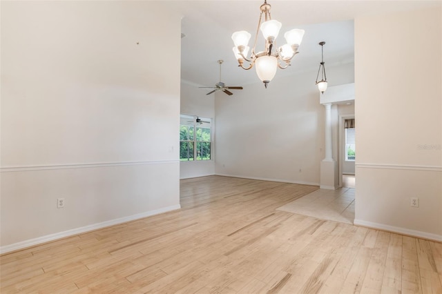 6029 Falconbridge Pl, Mount Dora, FL 32757 - empty room with a chandelier, ceiling fan, wood finished floors, and a towering ceiling