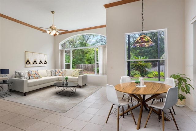 6029 Falconbridge Pl, Mount Dora, FL 32757 - dining area with healthy amount of natural light, ceiling fan, light tile patterned floors, a towering ceiling, and crown molding