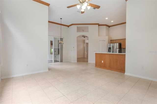 6029 Falconbridge Pl, Mount Dora, FL 32757 - unfurnished living room with ceiling fan, a high ceiling, ornamental molding, arched walkways, and recessed lighting