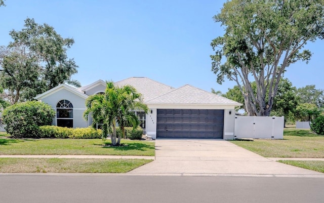 3780 Starlight Ave, Merritt Island, FL 32953 - view of front of property featuring an attached garage, driveway, stucco siding, and a gate