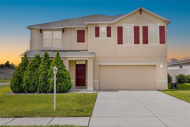 6060 Forest Ridge Ln, Winter Haven, FL 33881 - view of front of home with a garage, concrete driveway, a front yard, a shingled roof, and stucco siding