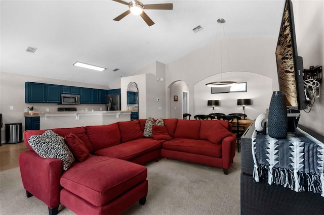 224 Highgate Park Blvd, Davenport, FL 33897 - living room featuring arched walkways, ceiling fan, light colored carpet, and high vaulted ceiling