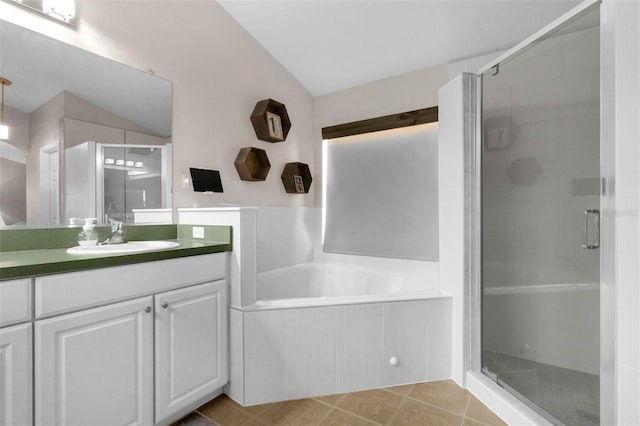 224 Highgate Park Blvd, Davenport, FL 33897 - full bathroom featuring lofted ceiling, vanity, a stall shower, a bath, and tile patterned floors