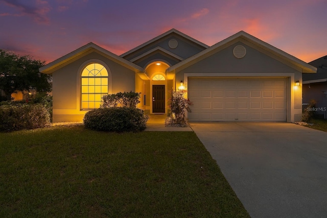 313 Cheshire Way, Davenport, FL 33897 - view of front of house featuring stucco siding, concrete driveway, a garage, and a front yard